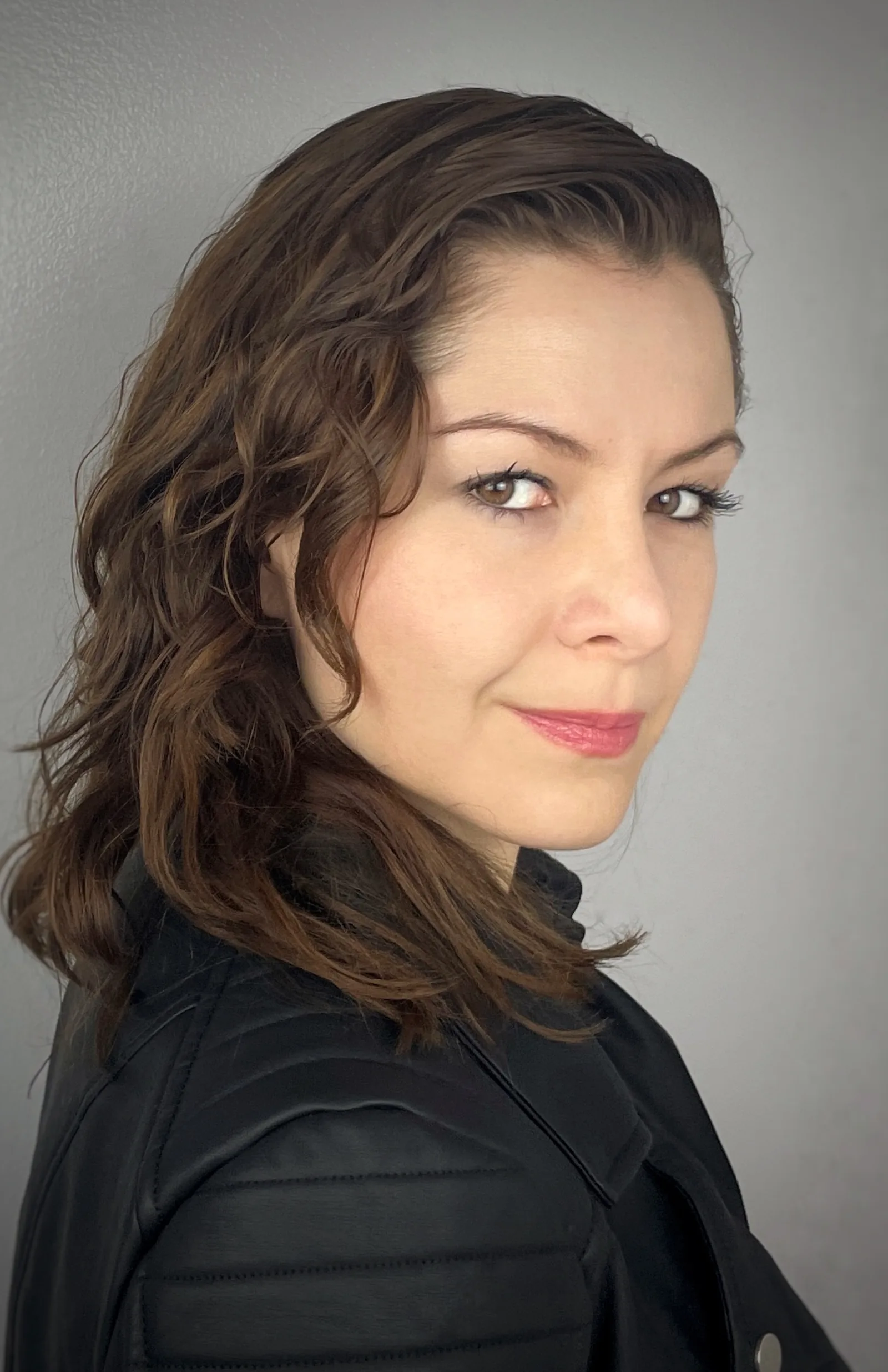 Wendy Lechuga in black leather jacket with curly hair — edgy, modern character headshot