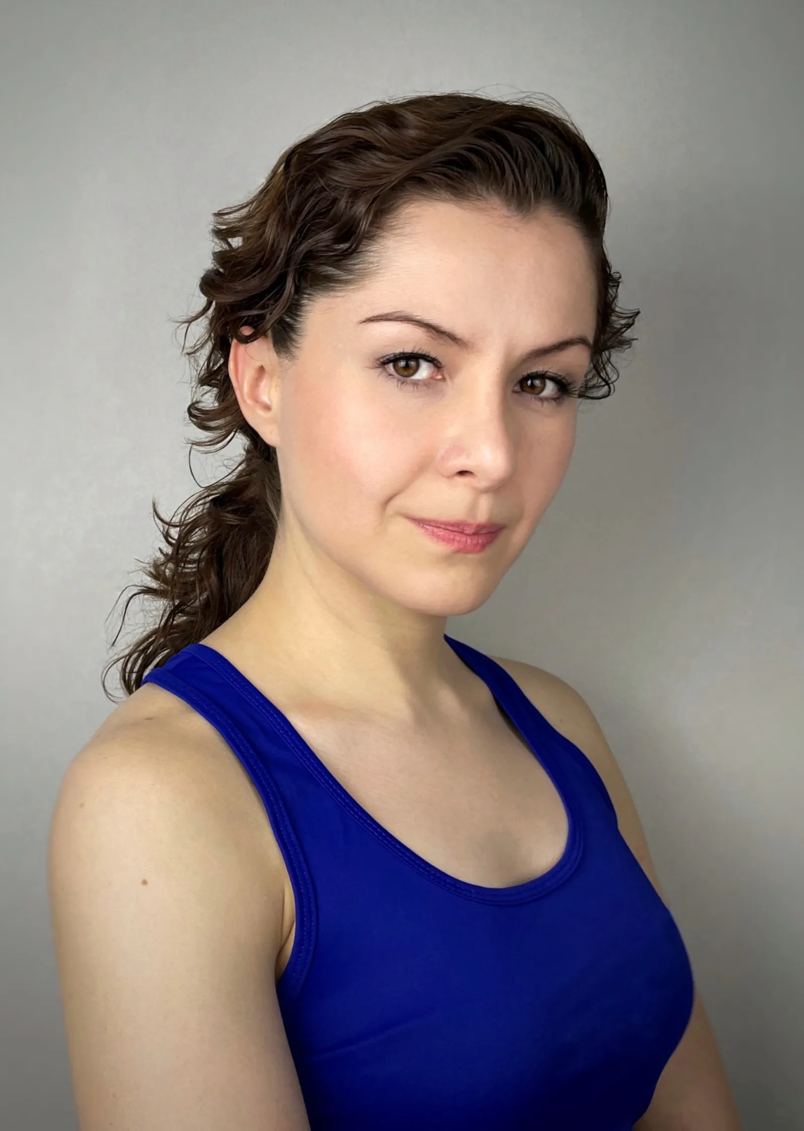 Wendy Lechuga in royal blue athletic tank top — bright, approachable commercial headshot